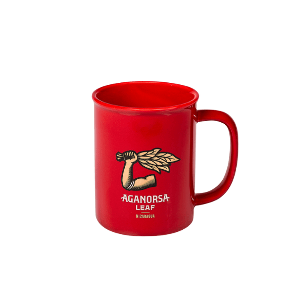The Aganorsa Leaf Ceramic Mug by Aganorsa Leaf Cigars is a red ceramic coffee mug with a raised fist holding tobacco leaves graphic and "AGANORSA LEAF NICARAGUA" text on the front.