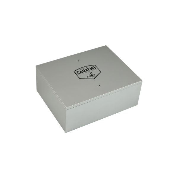 The Camacho 30 Cigar Desktop Humidor, a rectangular silver box with the Camacho logo on the lid, sits on a plain white background.