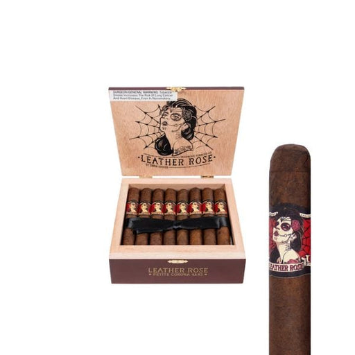 An open box of Deadwood Tobacco Leather Rose Petite Corona cigars by Deadwood Tobacco Cigars shows neatly arranged Brazilian Maduro sticks; the lid displays a tattooed woman with a rose and spiderweb, while one cigar stands upright beside the box.