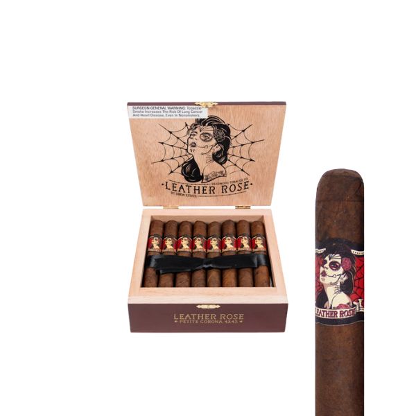 An open box of Deadwood Tobacco Leather Rose Petite Corona cigars displays bands with a woman's face and spiderweb design; one Petite Corona cigar is shown close up next to the box.