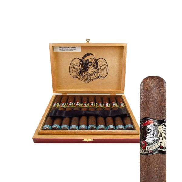 An open wooden box of Deadwood Fat Bottom Betty Robusto cigars by Drew Estate displays several cigars, each with a label showing a skeleton in a red bandana and the word "BET." One cigar is shown in close-up.