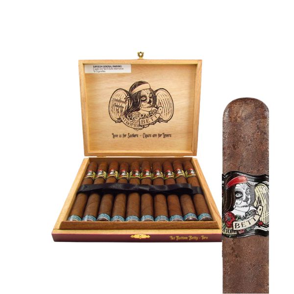 An open Deadwood Fat Bottom Betty Toro cigar box by Drew Estate displays cigars inside; artwork on the lid and a close-up highlight a detailed label with a woman’s face and the word "Bet".