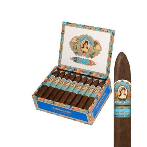 An open box of La Aroma De Cuba cigars reveals several Nicaraguan sticks inside, with one La Aroma De Cuba Mi Amor Belicoso cigar pictured close-up, highlighting its colorful vintage band design.