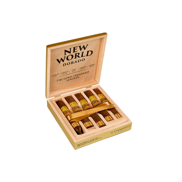 An open wooden box labeled "New World Dorado Sampler by AJ Fernandez" displays five Nicaraguan puro cigars from AJ Fernandez, each wrapped in cellophane and tied with a golden ribbon.