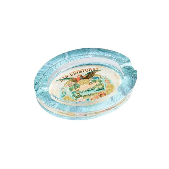 The San Cristobal Crystal Ashtray by San Cristobal Cigars features an elegant oval design with vibrant center imagery—an ideal addition to any cigar enthusiast's collection.