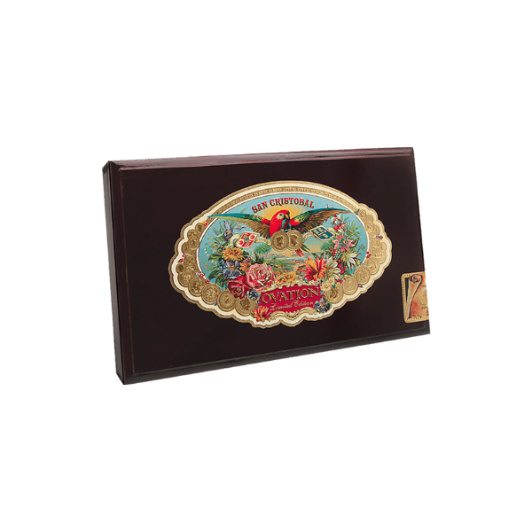 A rectangular box of San Cristobal Ovation Eminence cigars with a vibrant label featuring a parrot and floral designs, handcrafted by San Cristobal with premium Nicaraguan fillers and a rich San Andrés Oscuro wrapper.