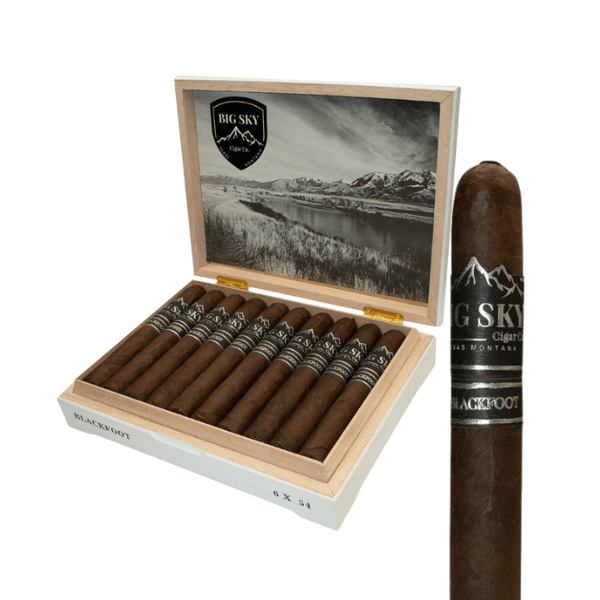 Open box of Big Sky Cigars Blackfoot Toro from Big Sky Cigar Co., with several cigars neatly arranged inside and one close-up cigar in the foreground. Wrapped in a flavorful San Andrés leaf, these cigars are perfect for outdoor enjoyment and offer a rich smoking experience. The box lid features a striking black and white landscape image.