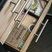 An open wooden drawer displays cigar boxes, a Boveda 69% Humidity Control Pack - Single (320g) by Boveda, and other cigar items—perfect for those who need large humidors and dependable humidity control.