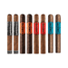 Eight premium cigars from the Camacho Bold Collection are lined up vertically, each featuring a distinctive branded label in black, orange, red, blue, or silver—a striking presentation of this renowned Honduran sampler.