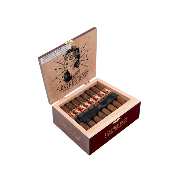 An open wooden box labeled "Deadwood Tobacco Leather Rose Petite Corona" displays several cigars. The lid showcases a woman with a rose and spider web, highlighting the Deadwood Tobacco Leather Rose Petite Corona.
