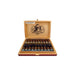 An open wooden cigar box displays two rows of Deadwood Fat Bottom Betty Robusto cigars by Drew Estate, featuring the illustrated logo and warning label on the inside lid.