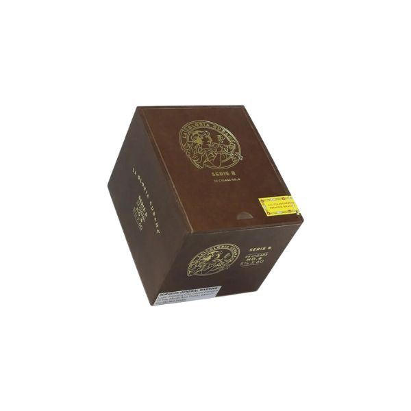 A sealed brown box with gold text and emblem, plus a yellow sticker, holds La Gloria Cubana Serie R No. 6 cigars by La Gloria Cubana. Photographed against a white background.