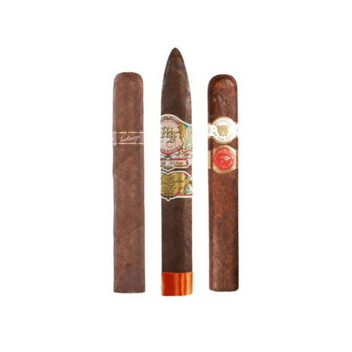Three premium cigars from After Action Cigars' Rare Breed Boutique Sampler stand upright with decorative bands on a white background, highlighting the sampler's boutique appeal.