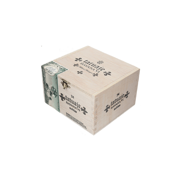 A light wooden box with a metal latch, adorned with "Tatuaje Havana VI Nobles" text and black floral motifs on the sides, plus a green decorative band on the top left corner. Inside, you'll find celebrated Nicaraguan cigars masterfully wrapped in an Ecuadorian Habano leaf.